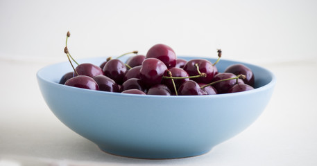 Red cherries in antique bowl