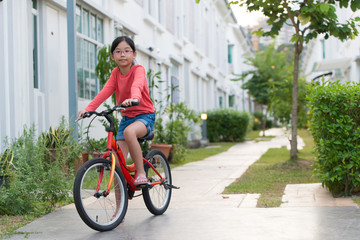 Fototapeta premium Little girl on bicycle