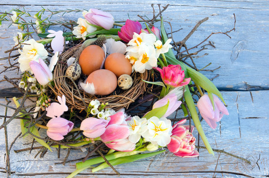 Happy Easter: nest with Easter eggs, feathers, tulips and daffodils:)
 