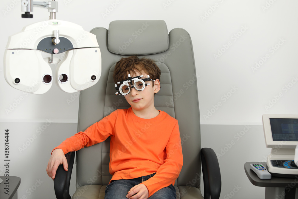 Poster eye examination, Optometrist in exam room with young boy 