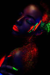 Beautiful woman portrait in neon colors on black background. Colorful make up, Bright colors. - 138714409