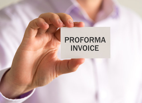 Businessman holding a card with PROFORMA INVOICE message