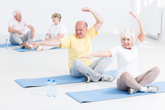 Senior people doing yoga exercises