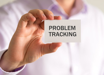 Businessman holding a card with PROBLEM TRACKING message