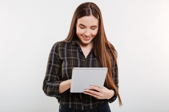 Smiling Woman in shirt using tablet computer