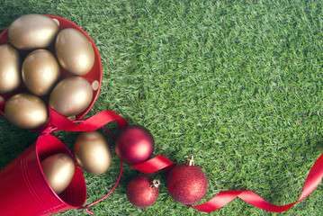 gold eggs with ribbon and red bucket