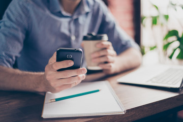Close up of man's hands texting and receiving messages on  telephone