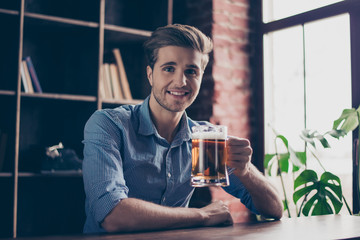 Cheerful happy smiling young man drinking beer