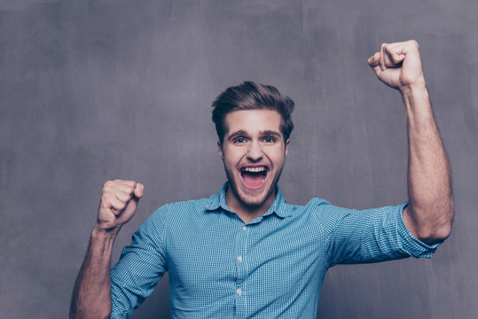 Yes! Portrait of happy successful man  with raised hands