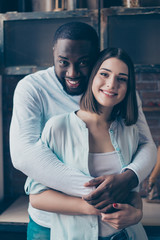 Handsome african man  embracing his beautiful  girl in kitchen