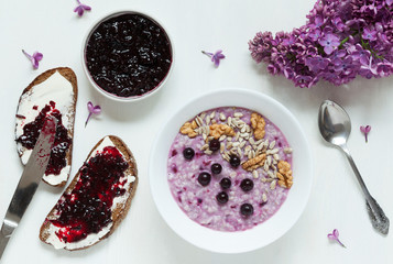 Healthy breakfast. Oatmeal porridge muesli with nuts, sunflower seeds, berries and berry jam. Сomplex carbohydrates