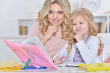 mother and daughter doing homework