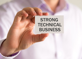 Businessman holding a card with STRONG TECHNICAL BUSINESS message