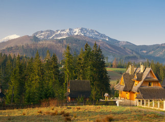 Scenic view of a wonderful valley in the mountains with wooden rural farm house buildings