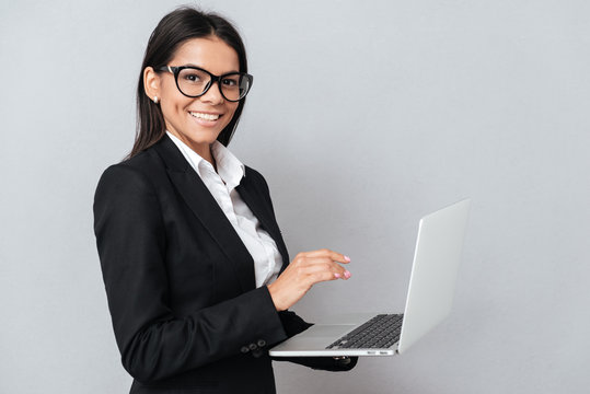 Side view of Business woman holding laptop