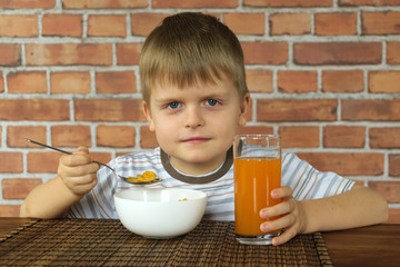 Cute little boy eating healthy food for breakfast