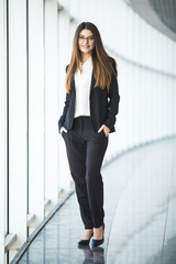 Fototapeta premium Full length portrait of happy business woman in office