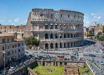 Fototapeta premium Aerial view of the Colosseum Amphitheater in Rome against blue sky background.