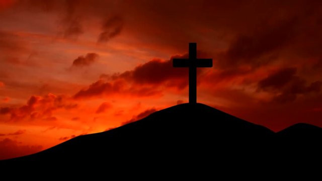 Timelapse of silhouette of christian cross on the hill at sunset time
