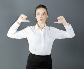 Beautiful serious  bussiness woman holds hands  fingers down