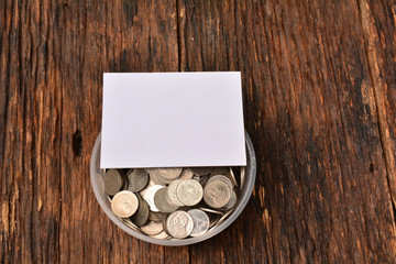 White paper mock up and stack coins in glass for save money and financial, tax season