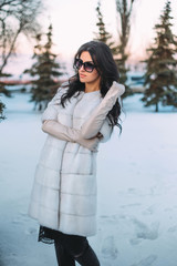 beautiful, young brunette posing on the street. Model wearing stylish warm clothes.