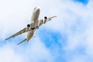 Aircraft banked turn in the sky and clouds