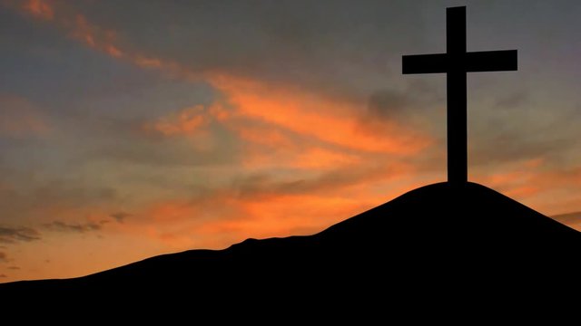 Timelapse of a christian cross on the mountain peak with red sky at sunrise time