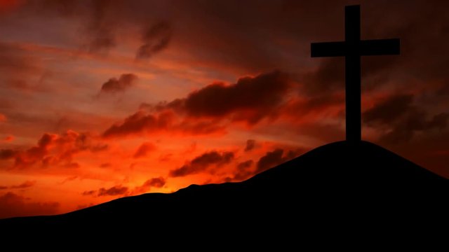 Video footage of silhouette of a christian cross on the hill at sunset time