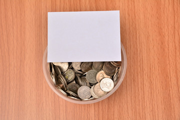 White paper mock up and stack coins in glass for save money and financial, tax season