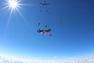 Skydivers are training in the blue sky