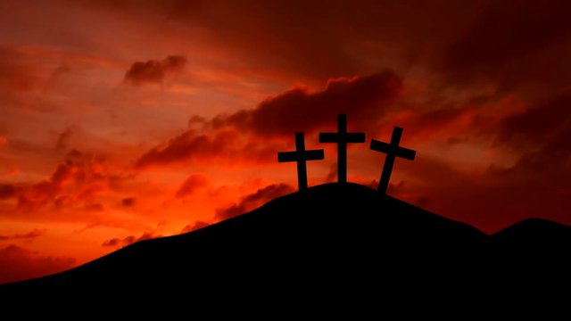 Silhouette of three christian cross on the hill with colorful sky at sunset time