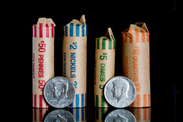 Coin rolls with half dollars.