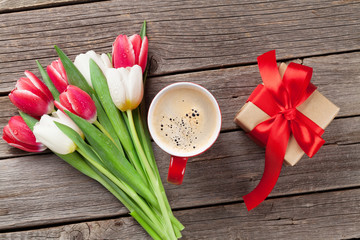 Colorful tulips, gift box and red coffee cup