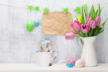 Easter eggs and pink tulips bouquet