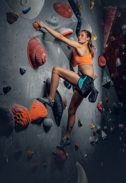 Female on indoor climbing wall.