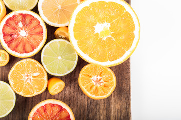 Fototapeta na wymiar Colorful fresh citrus fruit on wooden background. Orange, tangerine, lime, blood orange, grapefruit. Fruit background. Summer food concept. Flat lay, top view, copy space