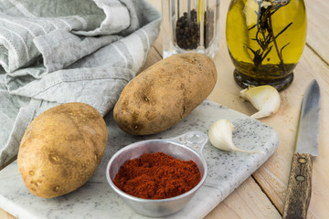 Ingredients for hasselback potatoes with smoked paprika and bacon.