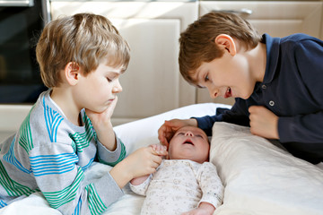 Two little kids boys playing with newborn baby sister girl © Irina Schmidt