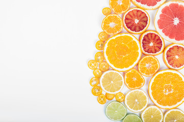 Colorful fresh citrus fruit on white background. Orange, tangerine, lime, blood orange, grapefruit. Fruit background. Summer food concept. Flat lay, top view, copy space