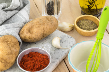 Ingredients for hasselback potatoes with smoked paprika and bacon.