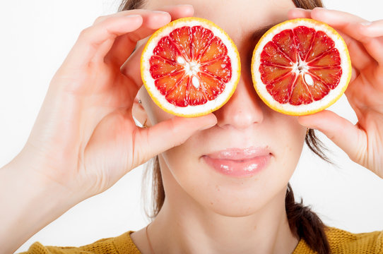 Healthy Eating Concept. Joyful Happy Young Woman Holding Juicy Oranges Before Her Eyes. Isolated Over White.