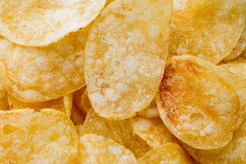 Close up potato chips on wood top view background.