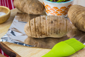 Ingredients for hasselback potatoes with smoked paprika and bacon.
