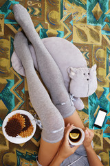 Teenage girl relaxing with some tea and waffels