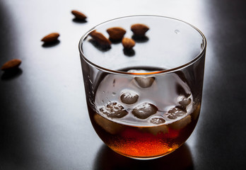 Amaretto almond liqueur with a dark background, top view
