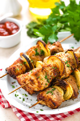 Grilled shish kebab or shashlik on skewers closeup on white background