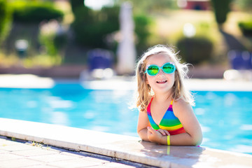 Child in swimming pool on summer vacation