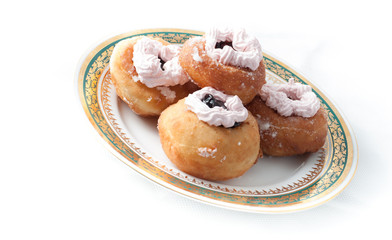 sweet donuts with cream on a plate