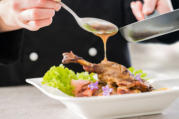 The chef prepares a gourmet meal.